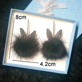 Fur ball bunny ears earrings